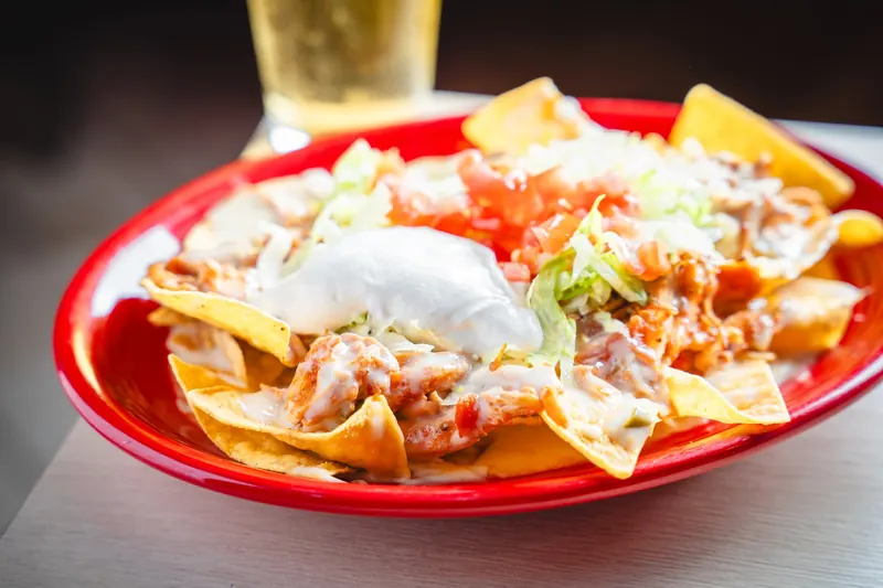 Nachos Supreme on a red platter